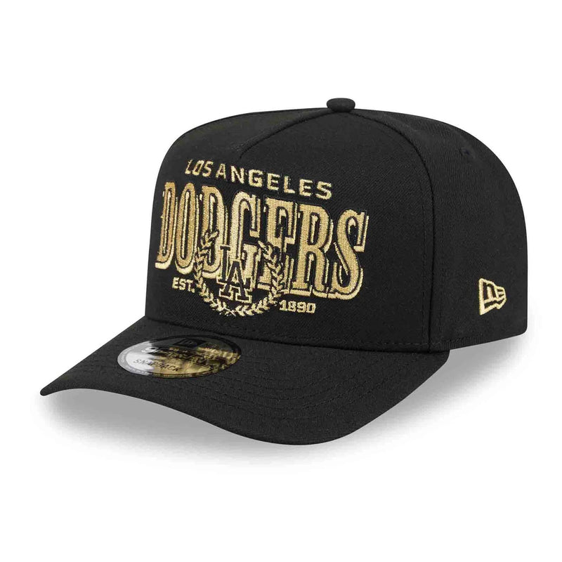 Load image into Gallery viewer, A black Los Angeles Dodgers baseball cap with gold embroidered lettering on the front and a small gold New Era logo on the side, shown on a clean white background.
