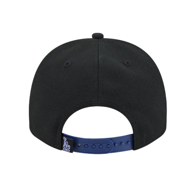 Load image into Gallery viewer, Rear view of a black baseball cap with a blue adjustable snapback strap and a small white embroidered logo on the side, shown on a white background.
