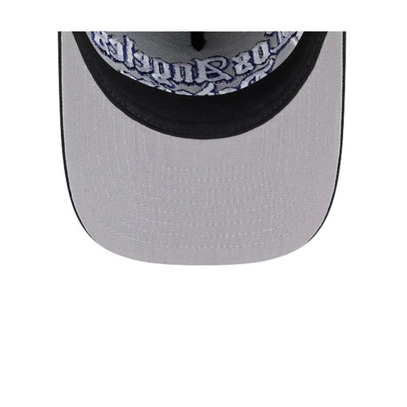Load image into Gallery viewer, Close-up of the front of a baseball cap showing a light gray brim, black curved brim edge, and a black embroidered front panel with white gothic-style text reading 'Los Angeles'.
