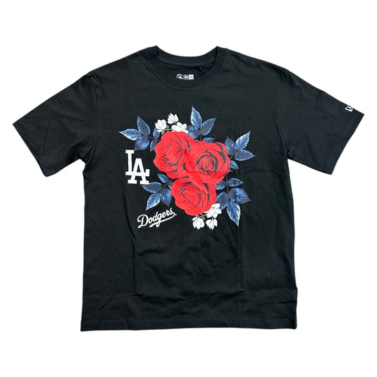 A black short-sleeve crewneck t-shirt featuring a graphic print of three red roses with blue leaves, white flowers, a white 'LA' logo, and 'Dodgers' script on the front.