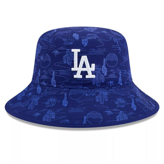 A royal blue bucket hat featuring an all-over desert-themed pattern in lighter blue, with a white embroidered 'LA' logo on the front, representing the Los Angeles Dodgers.