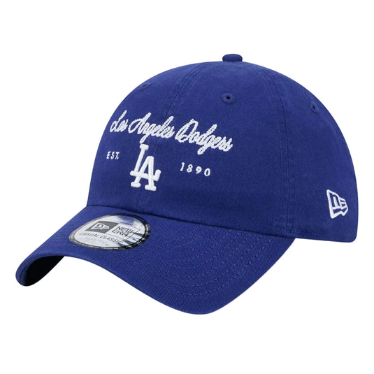 A royal blue Los Angeles Dodgers baseball cap by New Era, featuring white embroidered text and logos on the front, with a silver size sticker on the brim.