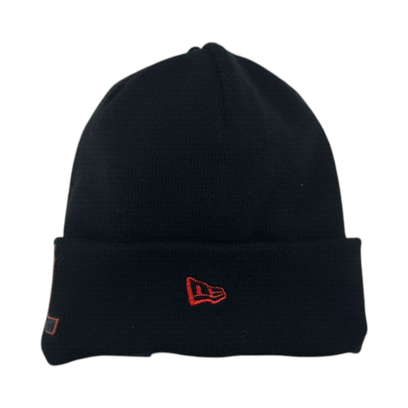 Load image into Gallery viewer, A black knit beanie hat with a folded cuff, featuring a red embroidered New Era flag logo on the front and a small side tag.
