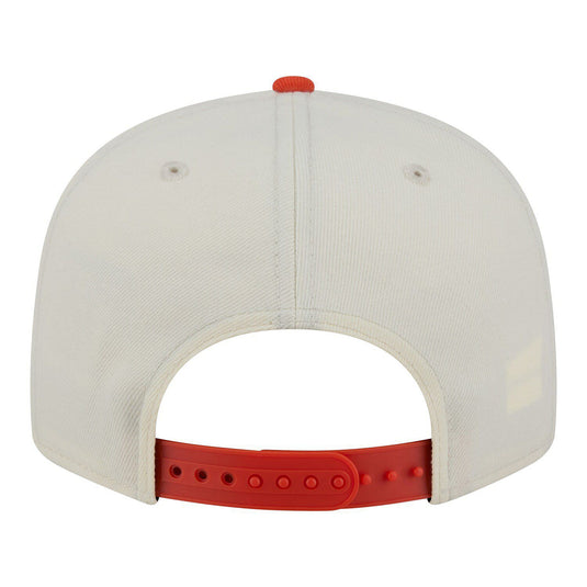 Back view of a white cap with a orange brim on a white background
