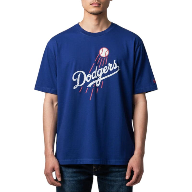 Load image into Gallery viewer, A man wearing a royal blue Los Angeles Dodgers t-shirt with a white and red graphic on the chest, paired with dark blue jeans, against a plain white background.
