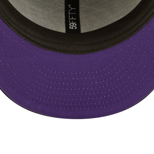 Close-up of a purple baseball cap with a black mesh back and '59Fifty' logo.