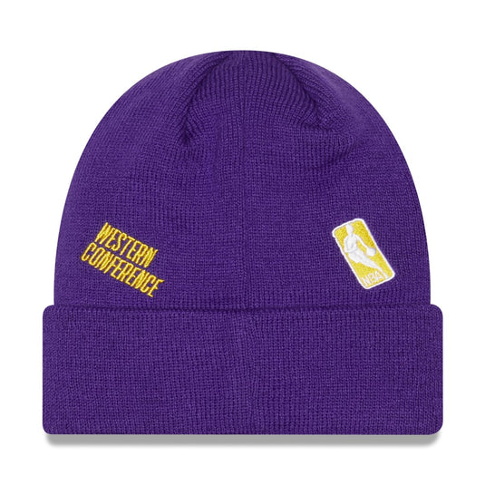 Back side of a purple Lakers beanie with various Lakers/NBA patches embroidered across the crown. 