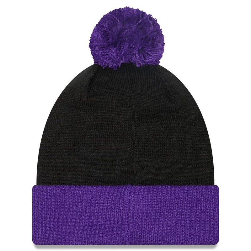 Load image into Gallery viewer, A black knit beanie hat with a fluffy purple pom-pom on top and a matching purple ribbed cuff, shown against a plain white background.
