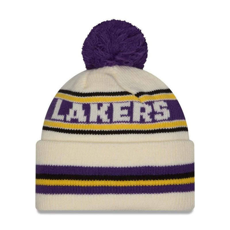 Load image into Gallery viewer, A knit pom-pom beanie hat in off-white with purple and yellow stripes, featuring the word 'LAKERS' in white with a purple outline on the front, set against a plain white background.
