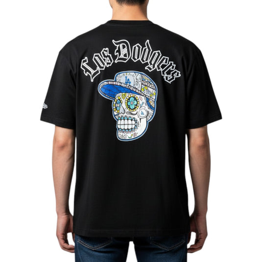Person wearing a black 'Los Dodgers' shirt with a sugar skull graphic on a white background.