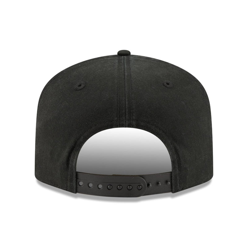 Load image into Gallery viewer, The back view of a black snapback cap on a solid white background.
