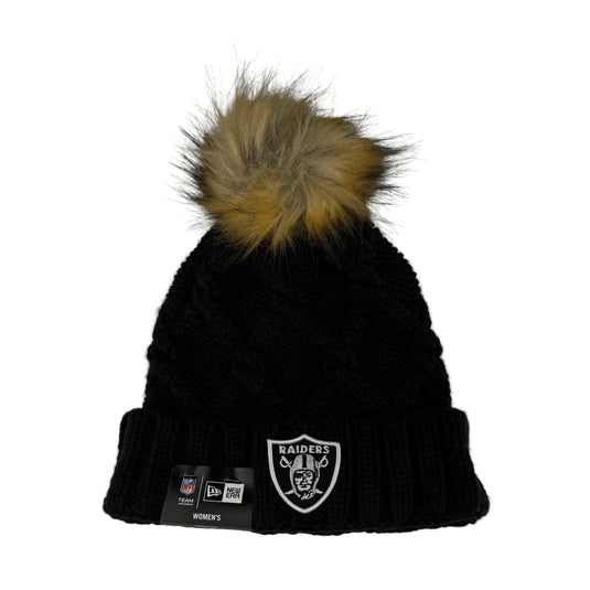 Black knit beanie with faux-fur pom-pom and NFL team Raiders logo on the cuff.