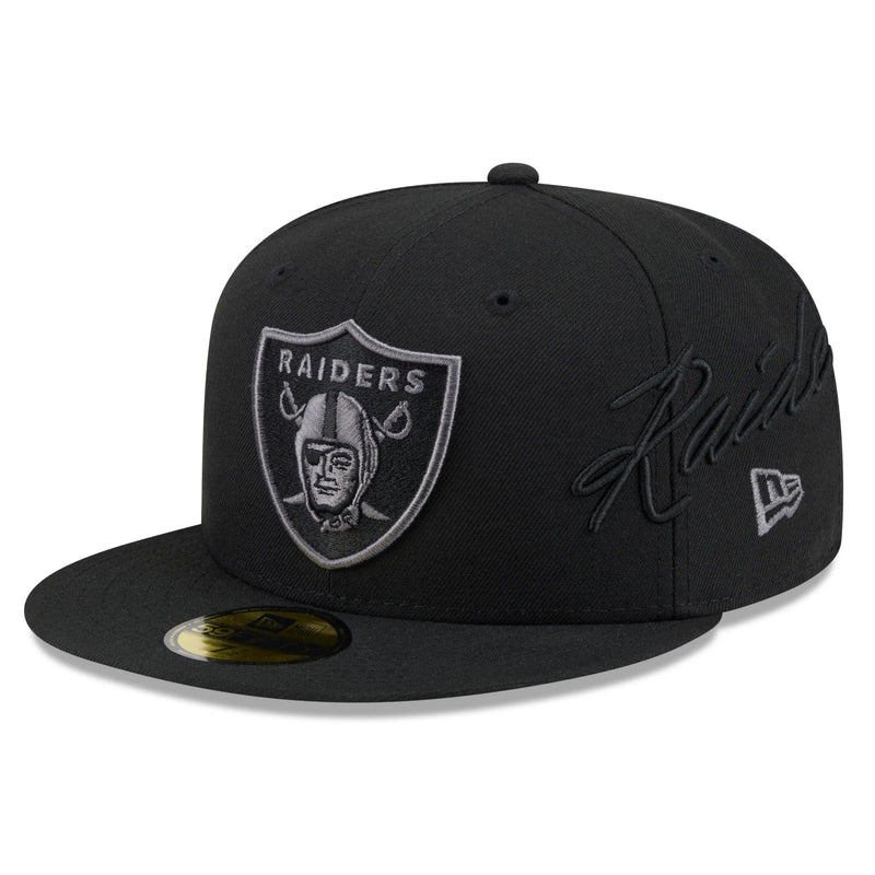 Load image into Gallery viewer, A black Oakland Raiders 59FIFTY fitted cap featuring a tonal black embroidered signature on the side and a gray embroidered Raiders shield logo on the front, shown on a white background.
