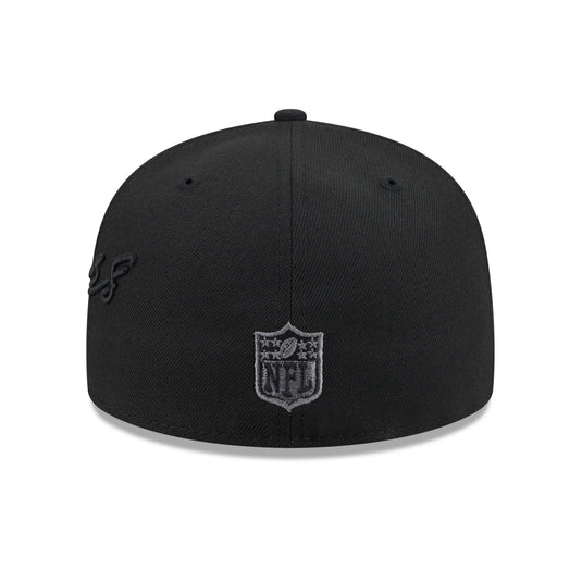 A black structured baseball cap featuring a NFL shield logo patch on the front and a subtle black embroidered script logo on the side, shown against a plain white background.