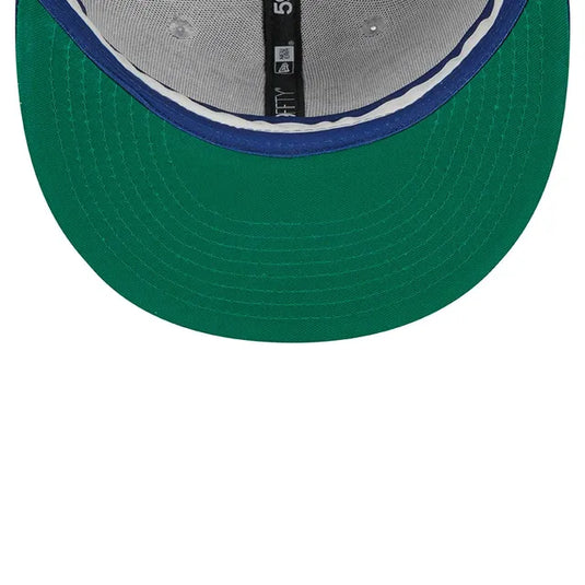 Green undervisor of a baseball cap with a close-up of the retro-style sweatband on a white background