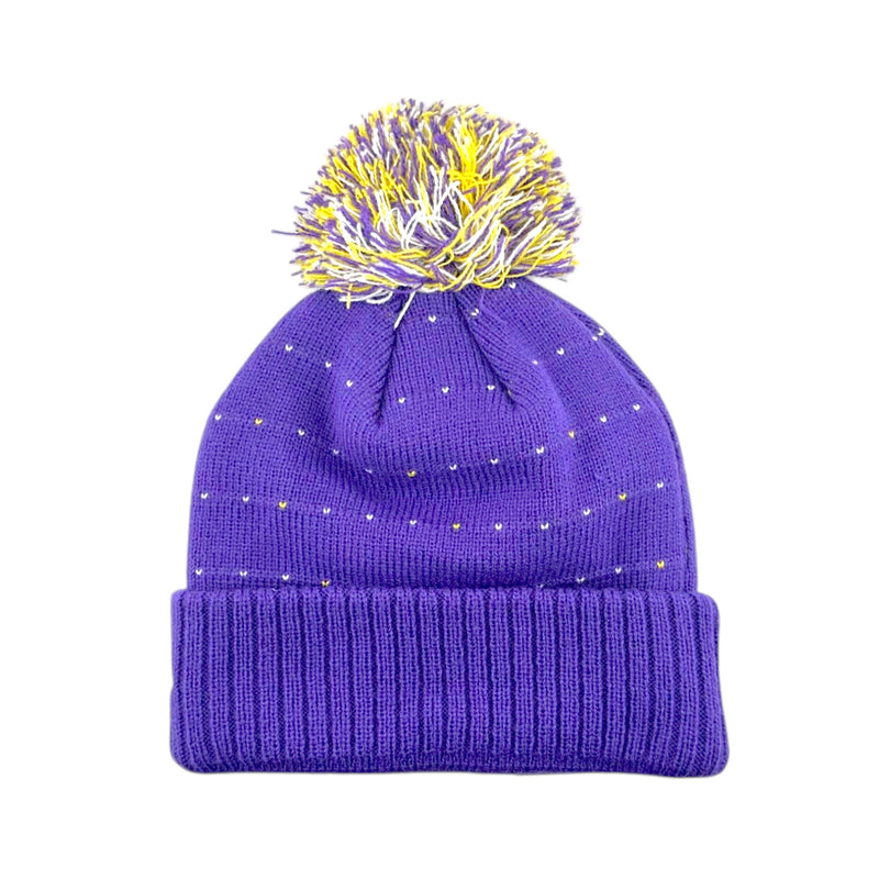 Load image into Gallery viewer, A purple knit beanie hat with a matching ribbed cuff and a fluffy pom-pom on top. The pom-pom is yellow and purple, and the beanie has small scattered gold dot accents.
