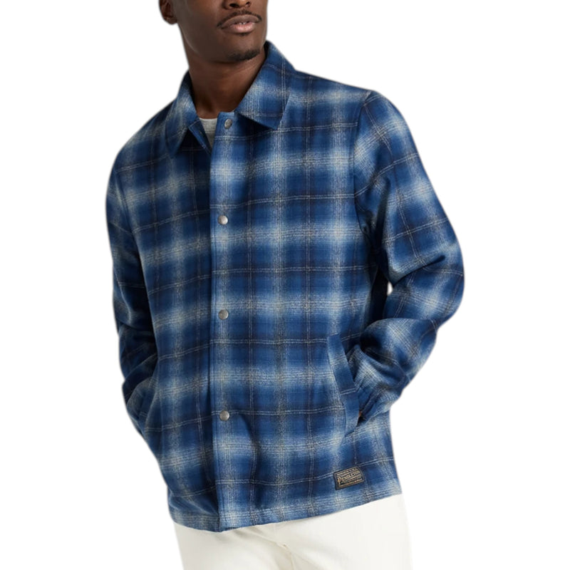 Load image into Gallery viewer, Man wearing a blue plaid shirt on a white background

