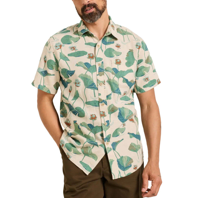 Load image into Gallery viewer, Man wearing a short-sleeve shirt with a tropical leaf pattern against a plain background
