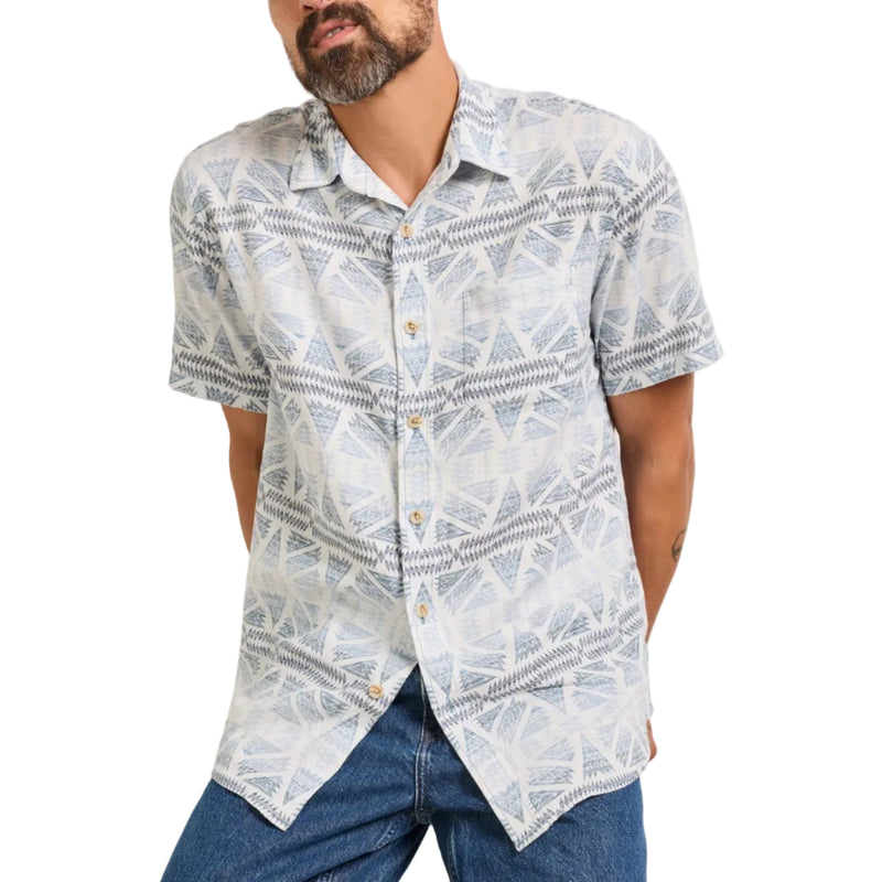 Load image into Gallery viewer, Man wearing a patterned short-sleeve shirt and jeans against a plain background
