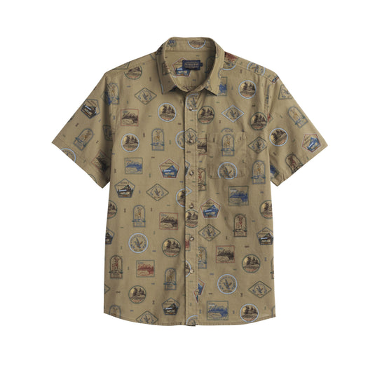 A short-sleeve button-up shirt in a tan/khaki color, featuring an allover print of vintage postage stamps in blue, red, and brown tones. The shirt is displayed flat against a solid white background.