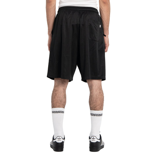 Person wearing black shorts on a white background