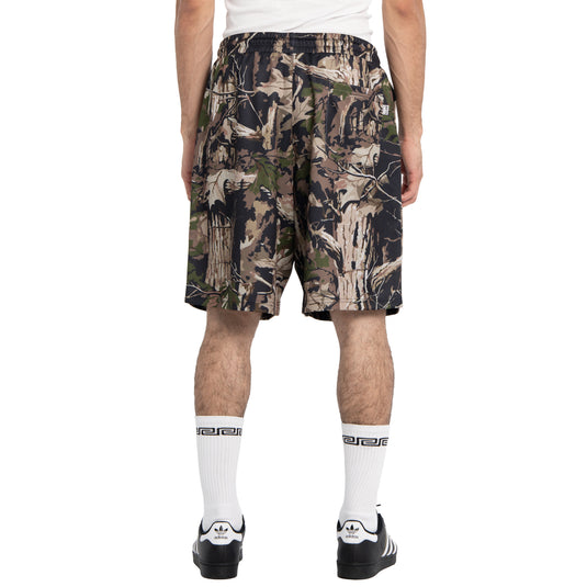 Person wearing camouflage shorts on a white background