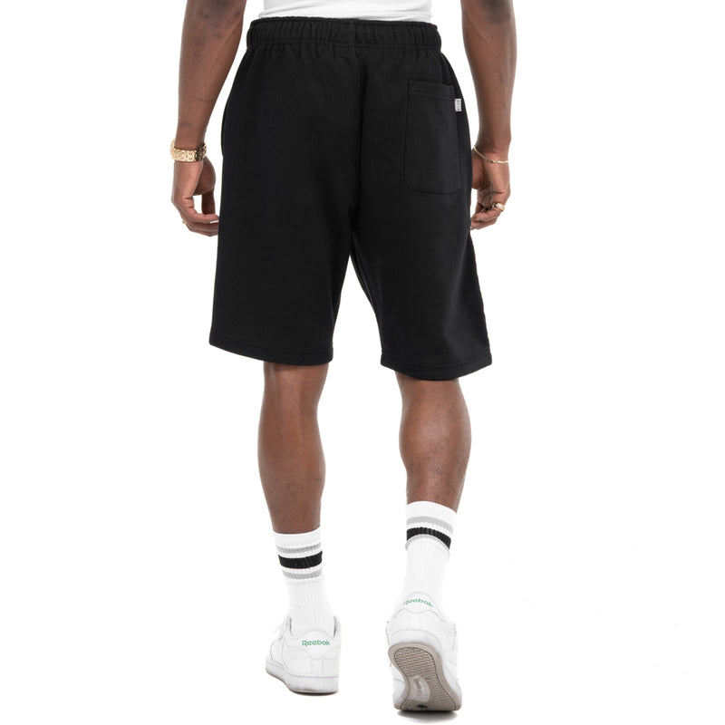 Load image into Gallery viewer, Back shot of Person wearing black sweat shorts with one rear pocket for the right leg on a white background

