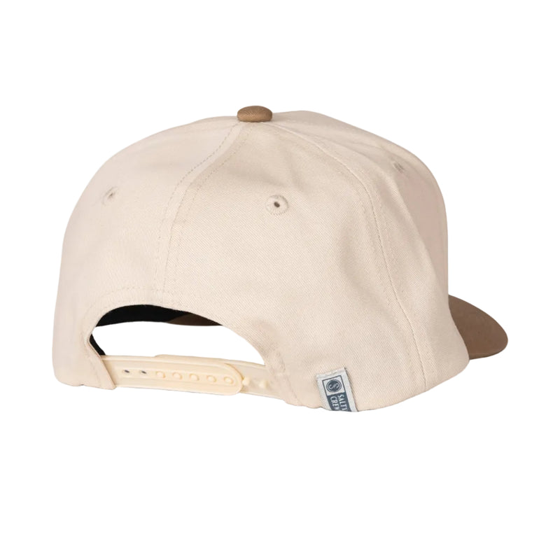 Load image into Gallery viewer, A light beige baseball cap shown from a rear three-quarter angle, featuring a tan visor and a matching tan button on top, photographed against a clean white background.
