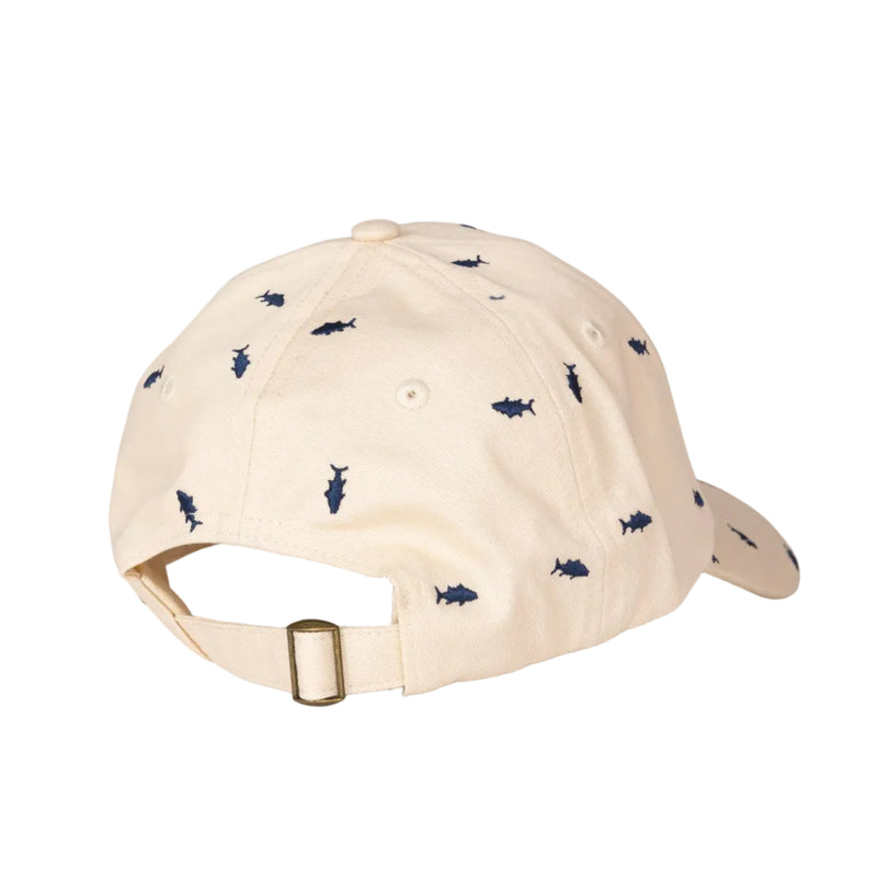 Load image into Gallery viewer, A light beige baseball cap with a pattern of small navy blue fish, shown from a three-quarters back view with its adjustable strap and gold-tone buckle visible, set against a plain light gray background.
