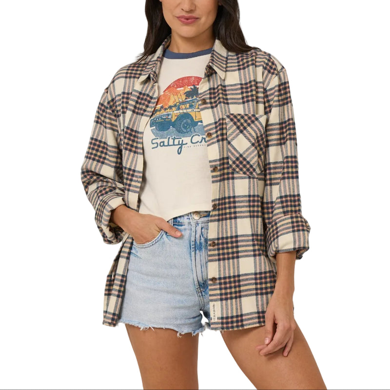 Load image into Gallery viewer, Woman wearing a plaid shirt over a graphic t-shirt with denim shorts on a plain background
