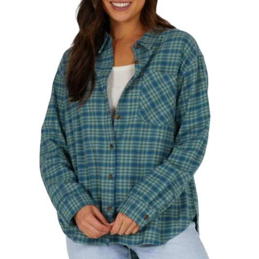 Woman wearing a green plaid shirt against a white background
