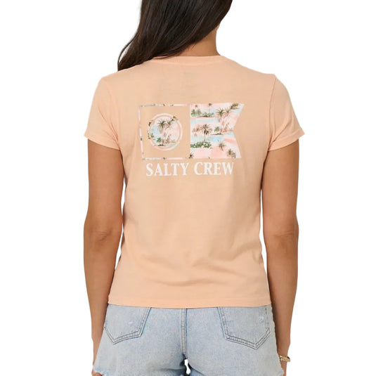 Person wearing a peach t-shirt with Salty Crew logo on the back, standing against a plain background