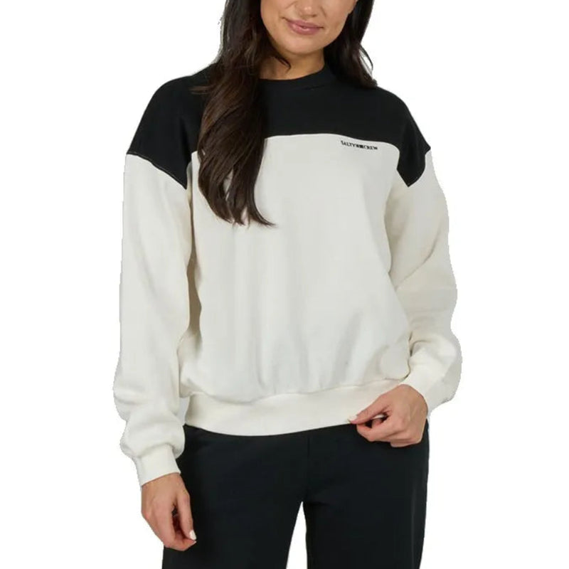 Load image into Gallery viewer, A woman modeling a colorblock sweatshirt with a black yoke and black sleeves, paired with black pants, against a solid white background.
