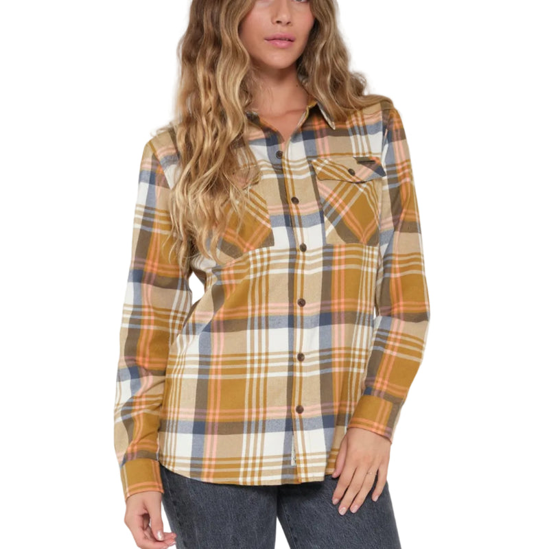 Load image into Gallery viewer, A woman modeling a Salty Crew long-sleeve button-up plaid flannel shirt in mustard yellow, beige, and blue, paired with dark gray jeans.
