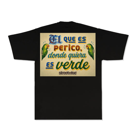 A black short-sleeve t-shirt with a large graphic print on the back. The graphic features a beige background with Spanish text reading 'El que es perico donde quiera es verde' in stylized blue, orange, and green lettering, flanked by two green parrots, and the brand name 'streetwise' printed below.