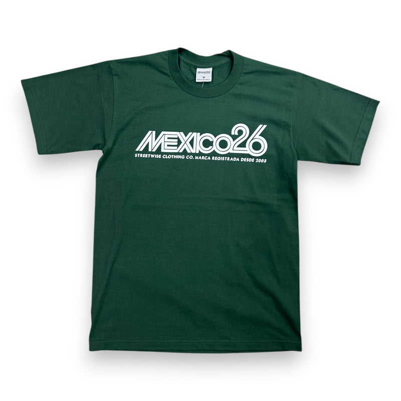 Load image into Gallery viewer, A dark green short-sleeve t-shirt with a white graphic print on the chest reading 'MEXICO26' and smaller text below, displayed flat against a white background.
