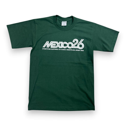 A dark green short-sleeve t-shirt with a white graphic print on the chest reading 'MEXICO26' and smaller text below, displayed flat against a white background.
