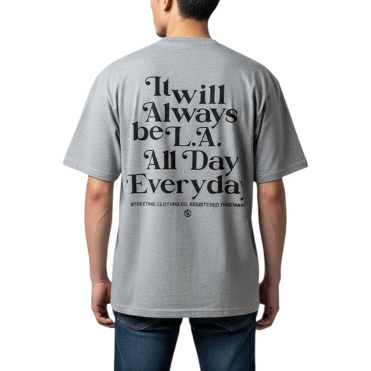 A man viewed from the back wearing a heather gray t-shirt with a large black typographic graphic on the back that reads 'It will Always be L.A.