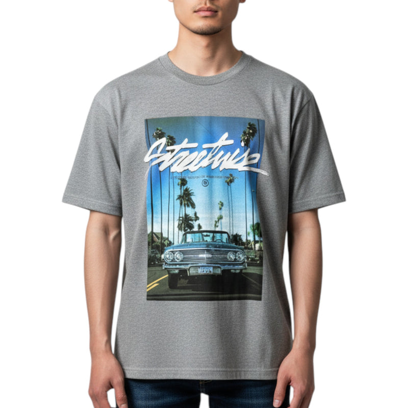 Load image into Gallery viewer, Person wearing a gray t-shirt with a graphic of a classic car and palm trees.
