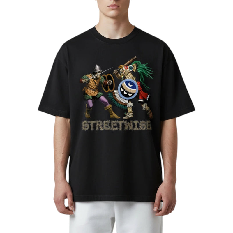 Load image into Gallery viewer, A model wearing a black oversized t-shirt with a colorful graphic of two street performers and the word 'STREETWISE' printed below it, paired with white pants against a plain white background.
