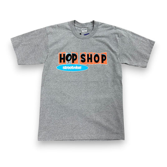 Gray t-shirt with a streetwise graphic that reads 'Hop Shop' in Black and Orange lettering on a white background