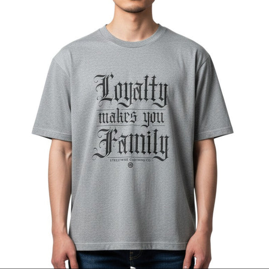Person wearing a gray t-shirt with 'Loyalty makes you family' text on a white background
