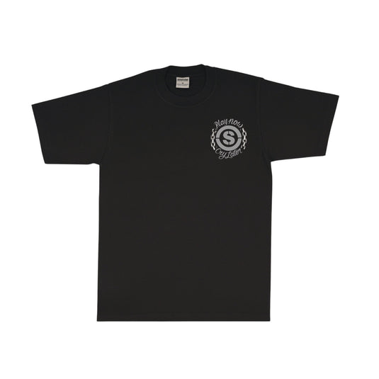 Black t-shirt with a circular 'S' logo and 'Play Now Cry Later' printed on the left chest. 