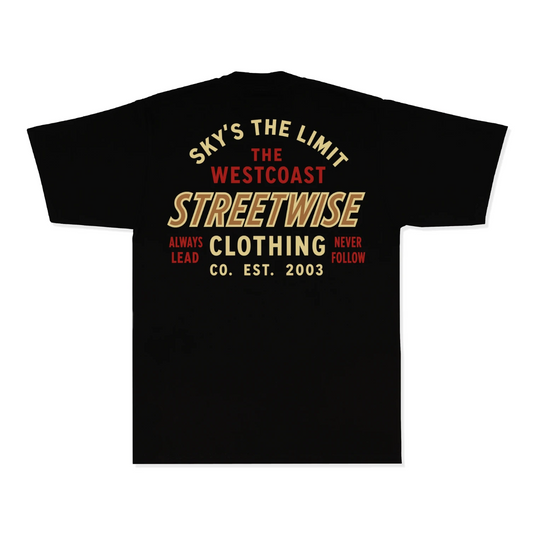 A black short-sleeve t-shirt shown from the back, featuring a vintage-style graphic print in gold and red text that reads 'SKY'S THE LIMIT THE WESTCOAST STREETWISE ALWAYS LEAD NEVER FOLLOW CO. EST.