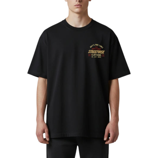 A man wearing an oversized black t-shirt with a vintage-style graphic on the left chest that reads 'STREETWISE CLOTHING EST. 1995' in yellow and red, set against a plain white background.