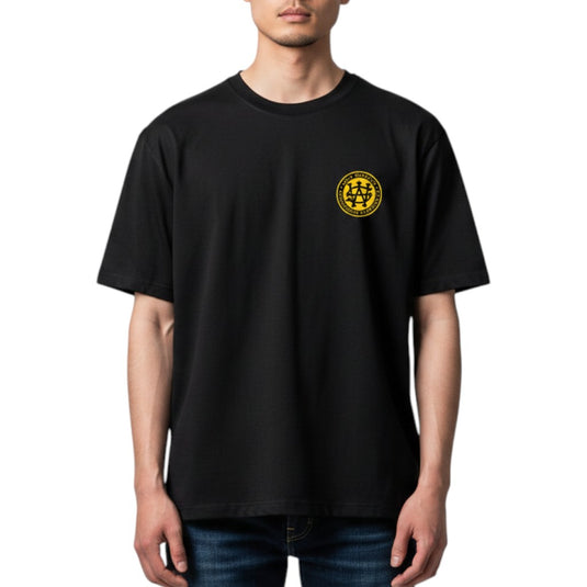 Person wearing a black t-shirt with a yellow logo on a white background