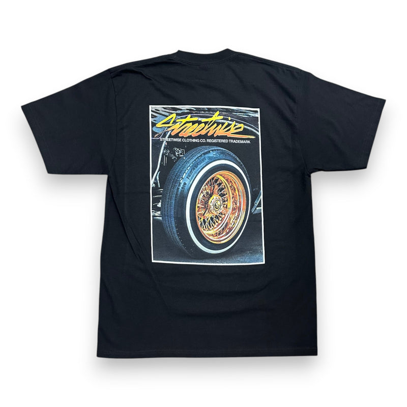 Load image into Gallery viewer, A black short-sleeve t-shirt shown from the back, featuring a large graphic print of a classic car wheel with the text 'Streetwise' in yellow and white.

