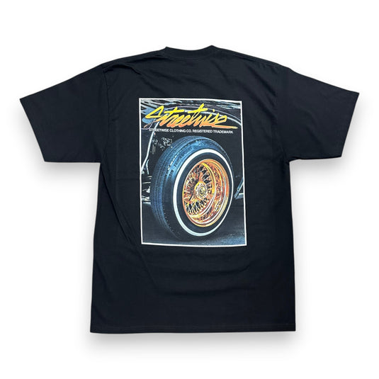 A black short-sleeve t-shirt shown from the back, featuring a large graphic print of a classic car wheel with the text 'Streetwise' in yellow and white.