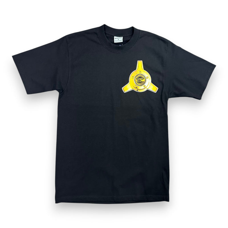 Load image into Gallery viewer, A black short-sleeve crewneck t-shirt featuring a yellow and black three-pointed star emblem with a central circular logo on the left chest, displayed against a plain white background.
