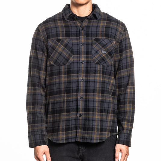 Black and yellow plaid flannel worn by a person on a white background